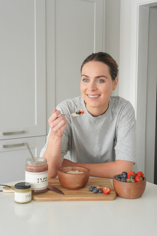 woman eating a spoon of porridge, fruit and irish sea moss